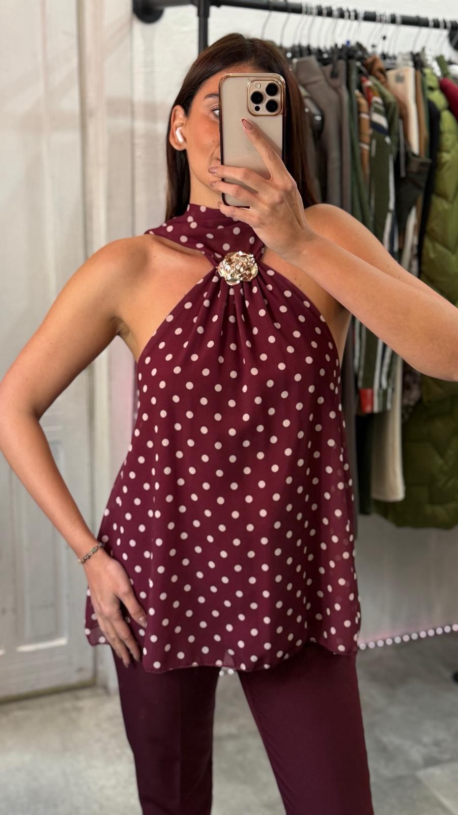 Top pois con laccio al collo e schiena scoperta e dettaglio fiore oro