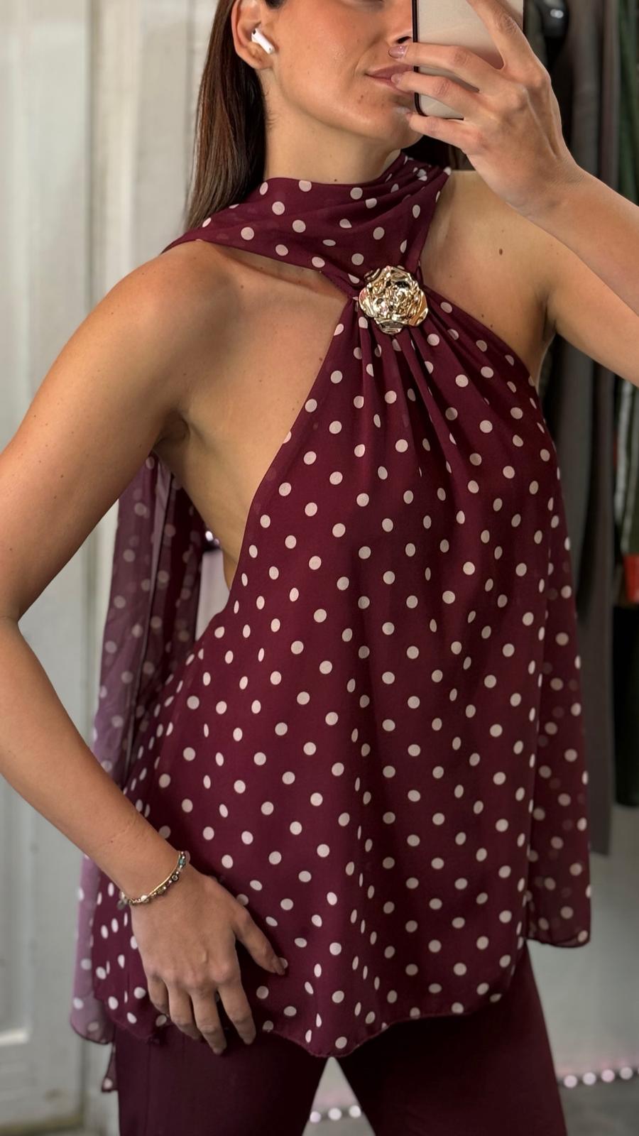 Top pois con laccio al collo e schiena scoperta e dettaglio fiore oro